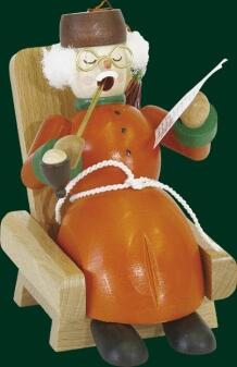 Räucherfigur Opa im roten Mantel mit Pfeife und Zeitung, gemütlich im Sessel sitzend aus Holz,