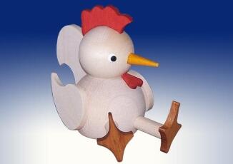 Ganzjahresfigur – liebevoll bemaltes Huhn, sitzend und farbenfroh, aus Holz – HxB = 7 x 4 cm
