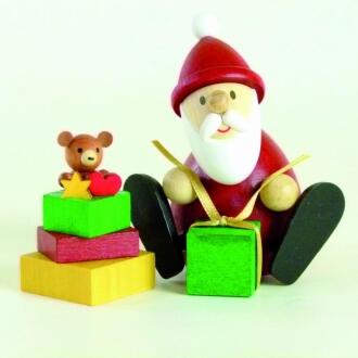Holzfigur – fröhlicher Weihnachtsmann mit buntem Geschenkestapel, detailreich bemalt von