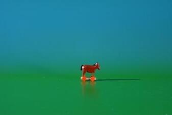 Miniaturfigur – liebevoll bemaltes Pferd auf rollbarem Holzgestell in Bunt – HxBxT ca. 2,6x3x1,5 cm“